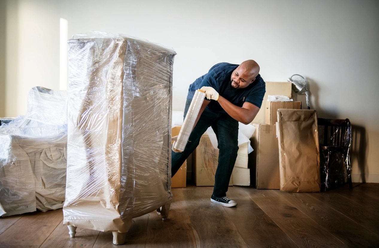 A man holding onto a piece of cardboard